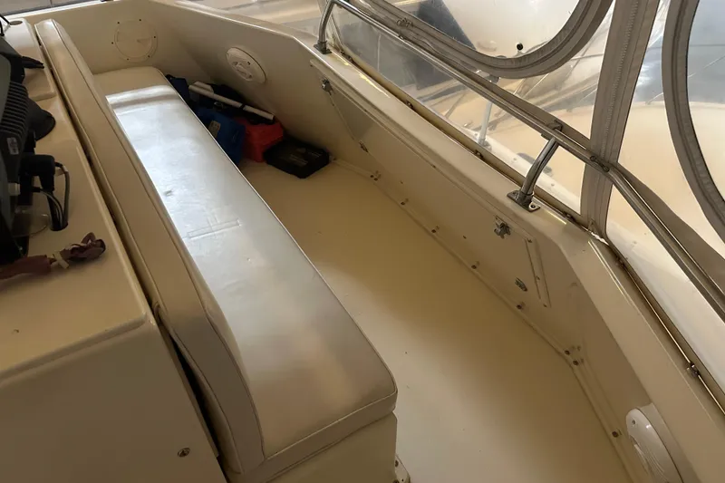 Slide: The Image of 1989 Egg Harbor 37 Convertible boat interior with cushioned seating and storage area. - 44