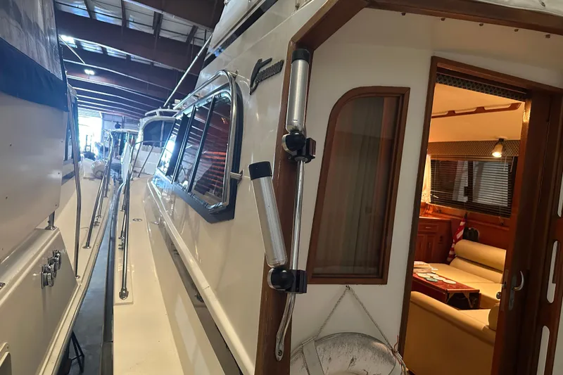 Slide: The Image of 1989 Egg Harbor 37 Convertible yacht interior view with cozy seating and wooden accents. - 47