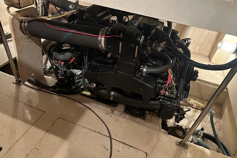 Slide: The Image of Engine compartment of a 1989 Egg Harbor 37 Convertible boat, showcasing mechanical components. - 49