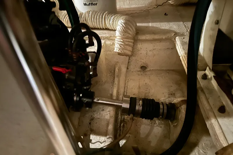 Slide: The Image of Engine compartment of a 1989 Egg Harbor 37 Convertible boat, showing mechanical components. - 54