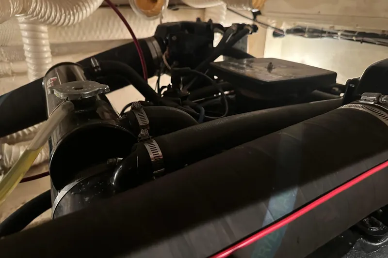 Slide: The Image of Engine room of 1989 Egg Harbor 37 Convertible with visible hoses and components. - 56