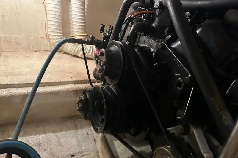 Slide: The Image of Engine compartment of 1989 Egg Harbor 37 Convertible boat, showing belts and hoses. - 59