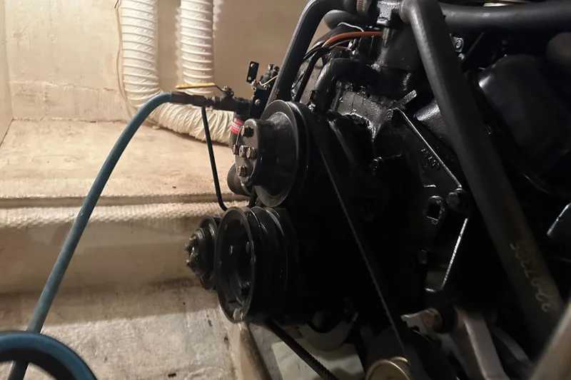 Slide: The Image of Engine compartment of a 1989 Egg Harbor 37 Convertible boat, showing mechanical components. - 60