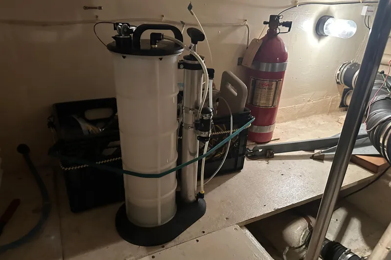 Slide: The Image of Engine room of 1989 Egg Harbor 37 Convertible with fire extinguisher and equipment. - 62