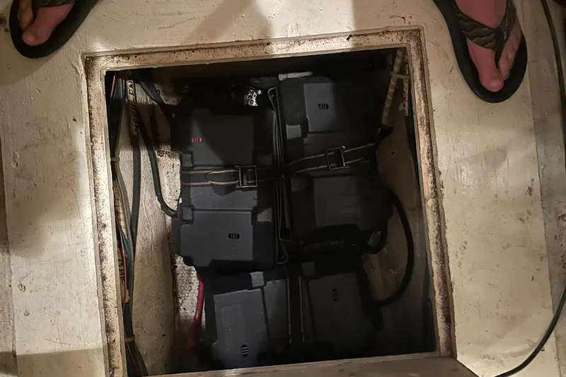 Slide: The Image of Battery compartment of a 1989 Egg Harbor 37 Convertible boat, showing secured batteries. - 63