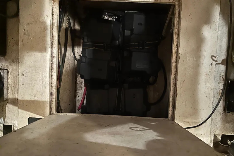 Slide: The Image of Battery compartment of a 1989 Egg Harbor 37 Convertible boat, showing wiring and battery boxes. - 64