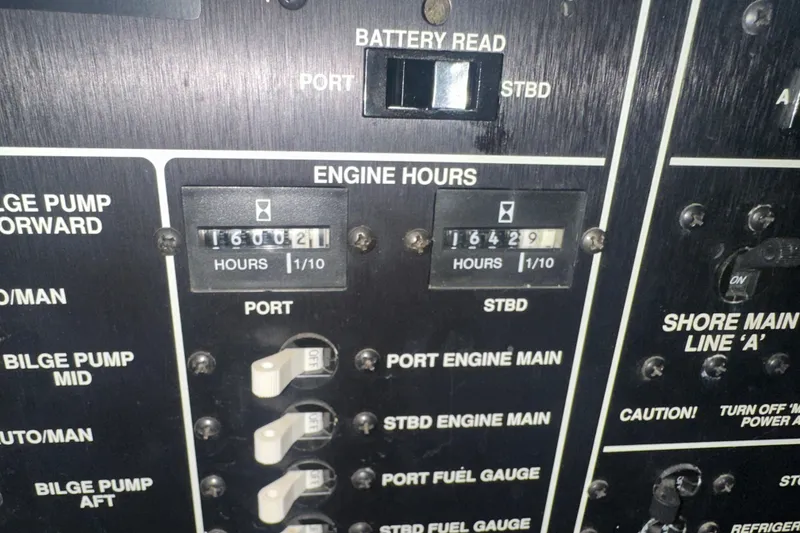 Slide: The Image of Control panel of 1989 Egg Harbor 37 Convertible showing engine hours and switches. - 65