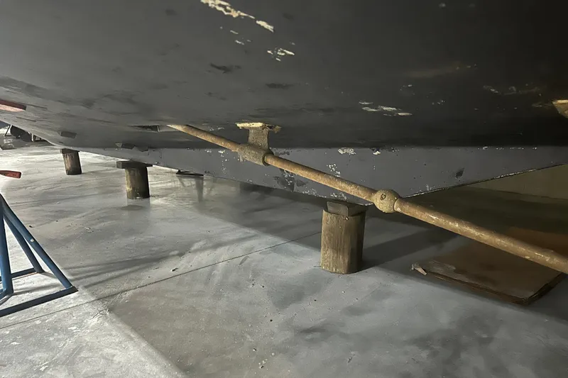 Slide: The Image of 1989 Egg Harbor 37 Convertible boat hull on supports in a workshop. - 69