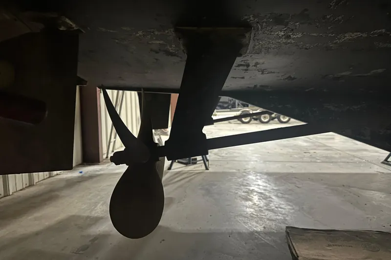 Slide: The Image of Propeller and shaft of 1989 Egg Harbor 37 Convertible boat in a workshop. - 71