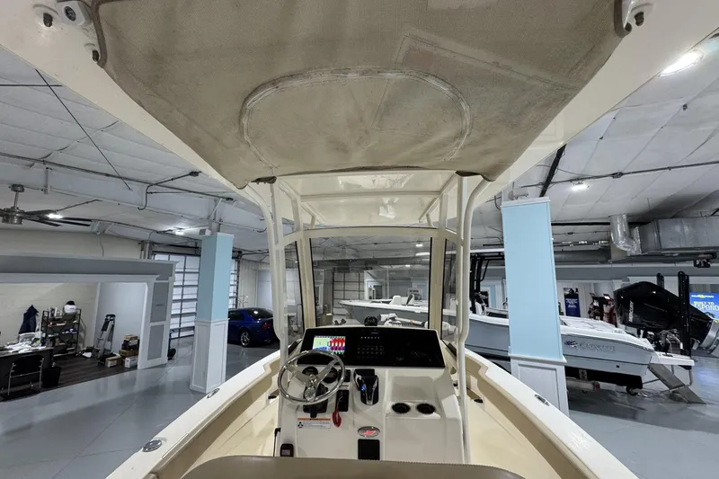 Slide: The Image of 2023 Scout 215 XSF boat interior with steering wheel and control panel in showroom. - 8