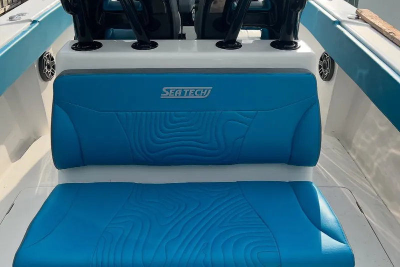Slide: The Image of 2023 Sea Tech 33 CC boat interior with blue seating and logo. - 3