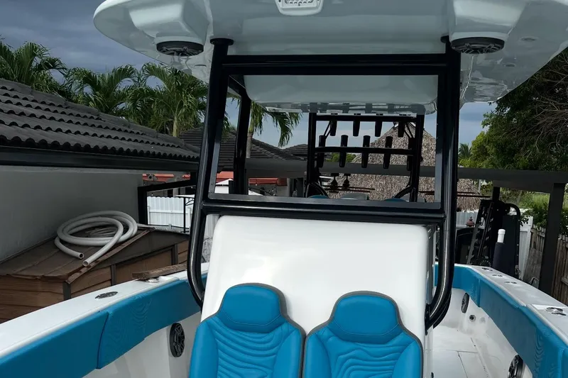 Slide: The Image of 2023 Sea Tech 33 CC boat with blue seating and sleek design. - 6