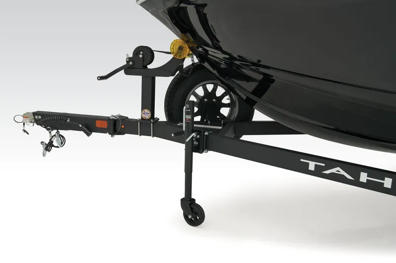 Slide: The Image of Trailer hitch of 2018 Tahoe 450 TS boat, featuring black finish and wheel support. - 9