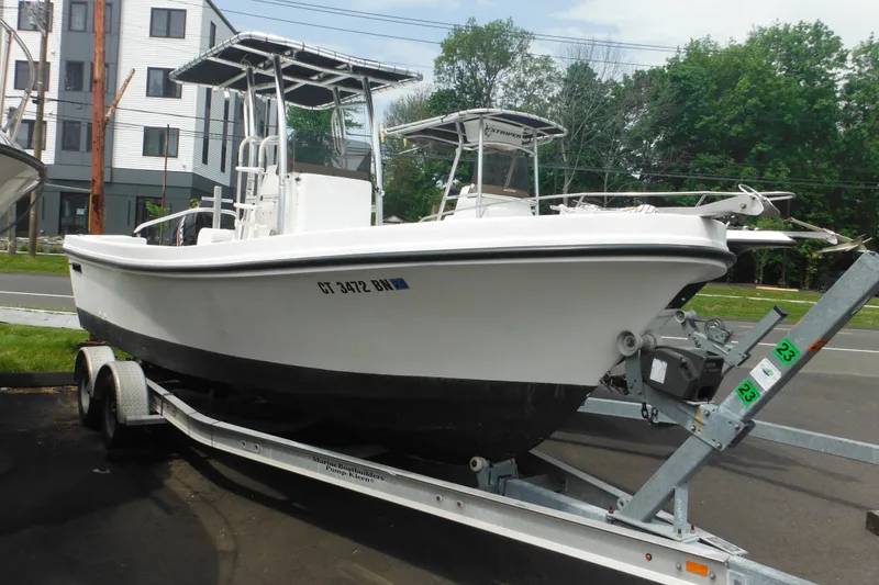 The Image of 2006 DC 23 DC Brown Custom CC boat on trailer, parked outdoors. - 1