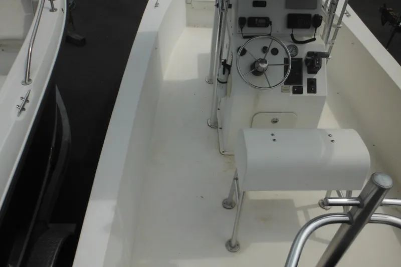 Slide: The Image of 2006 DC 23 DC Brown Custom CC boat interior with steering console and seating. - 11