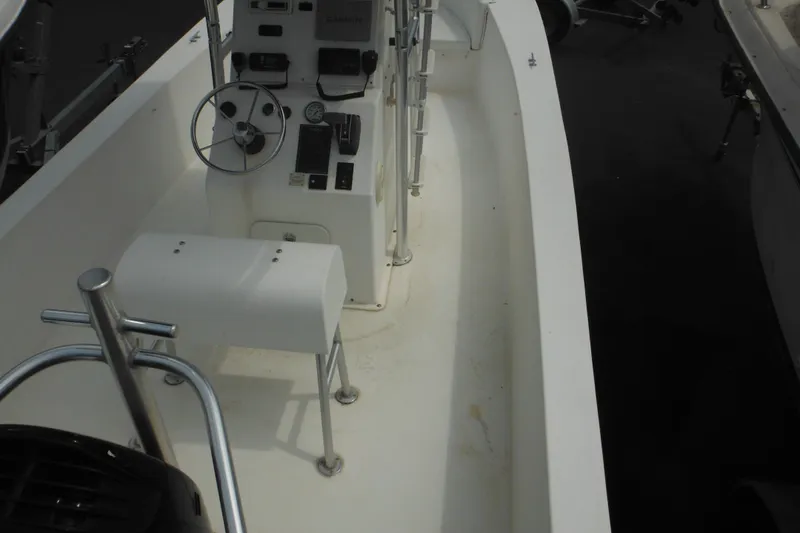Slide: The Image of 2006 DC 23 Brown Custom CC boat interior with steering wheel and control panel. - 12