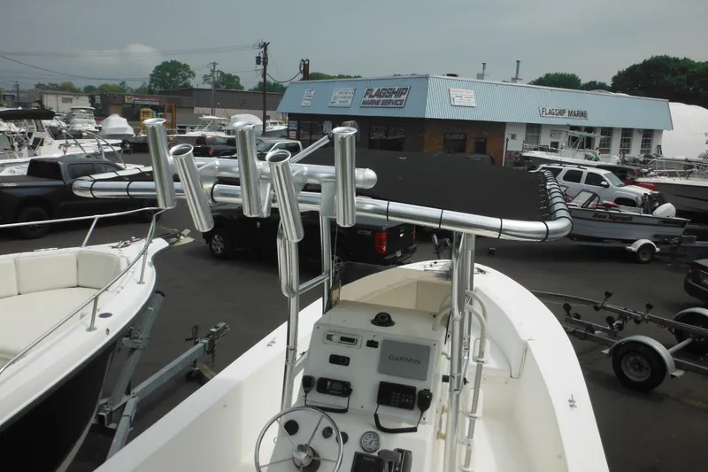 Slide: The Image of 2006 DC 23 Brown Custom CC boat with rod holders at a marine service center. - 13