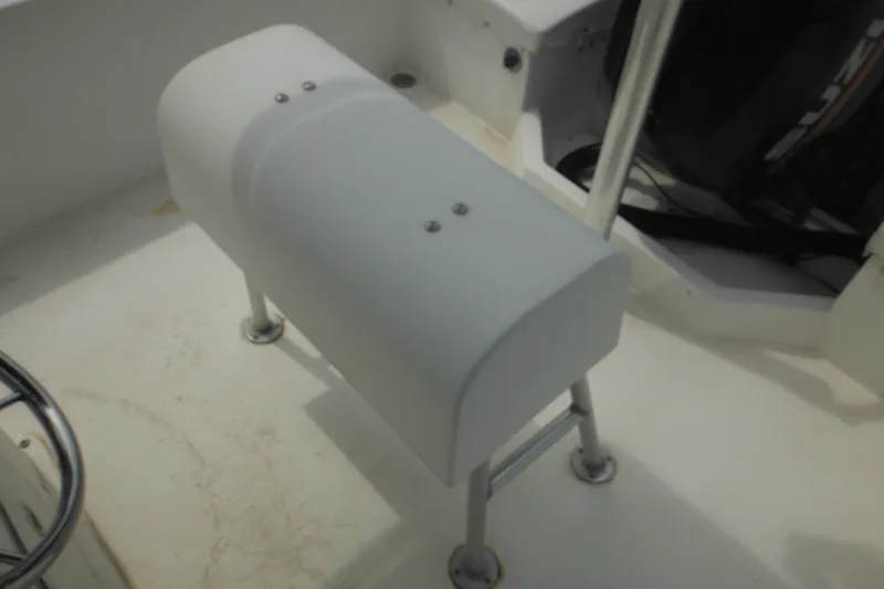 Slide: The Image of 2006 DC 23 Brown Custom CC boat interior with white seat and metal frame. - 16