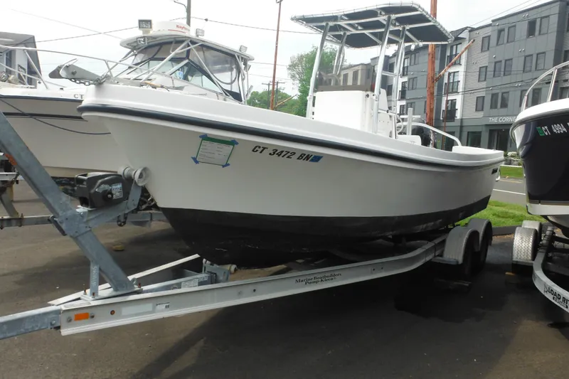 Slide: The Image of 2006 DC 23 Brown Custom CC boat on trailer, parked outdoors. - 2