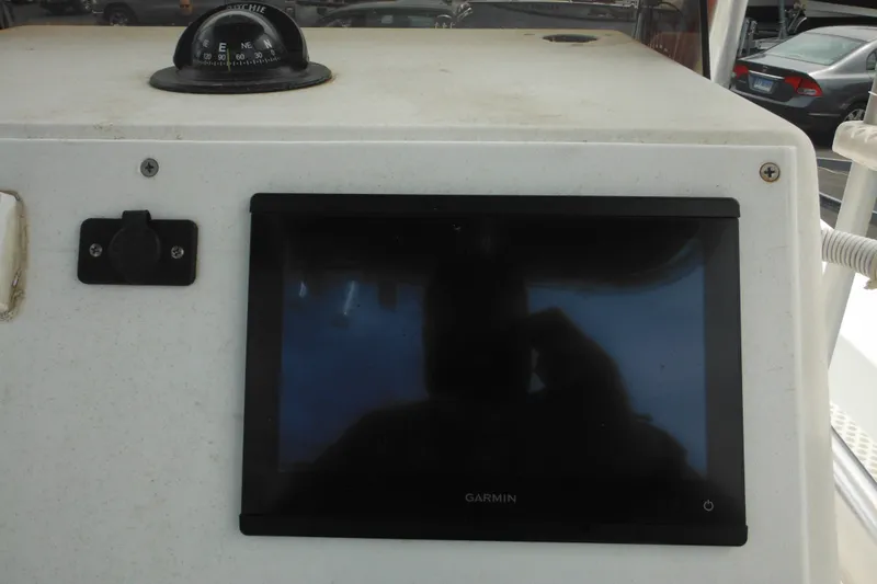 Slide: The Image of Boat dashboard with Garmin display and compass, 2006 DC 23 Brown Custom CC. - 21