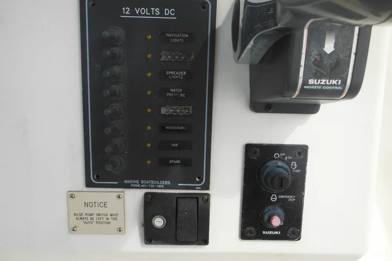 Slide: The Image of Control panel of a 2006 DC 23 Brown Custom CC boat with Suzuki remote control. - 23
