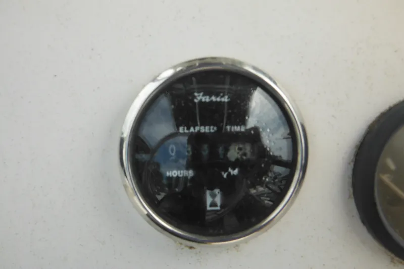 Slide: The Image of Hour meter on 2006 DC 23 DC Brown Custom CC boat dashboard. - 24