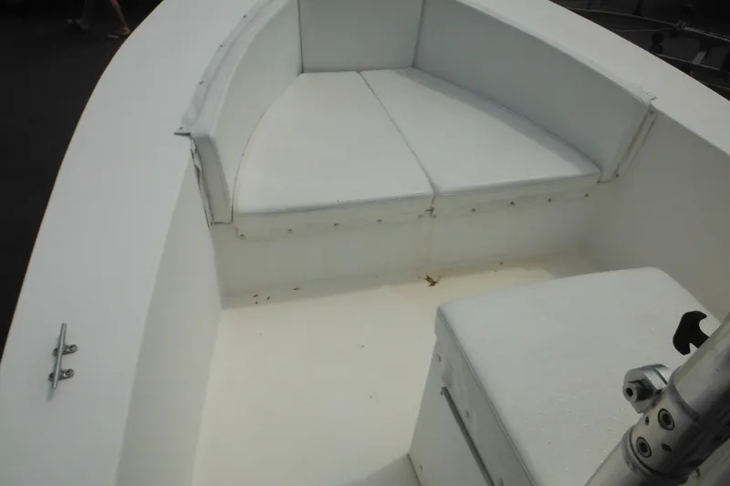 Slide: The Image of 2006 DC 23 DC Brown Custom CC boat interior with white seating and clean deck. - 27