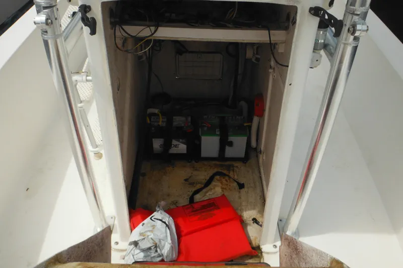 Slide: The Image of 2006 DC 23 Brown Custom CC boat storage compartment with battery and safety equipment. - 31