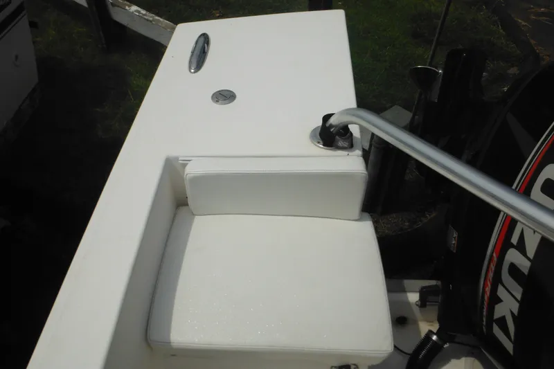 Slide: The Image of White cushioned seat on 2006 DC 23 DC Brown Custom CC boat, near Suzuki engine. - 36