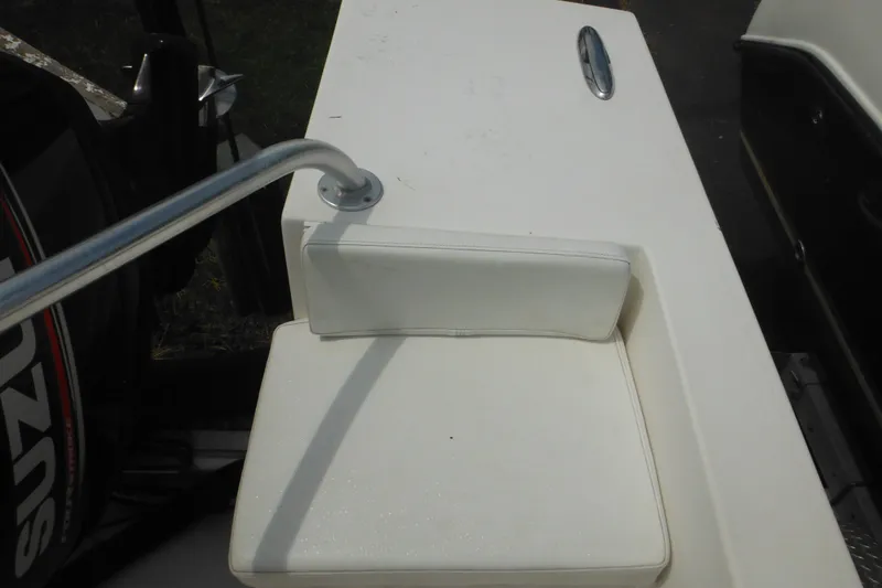 Slide: The Image of White seat on a 2006 DC 23 Brown Custom CC boat with railing and engine. - 37