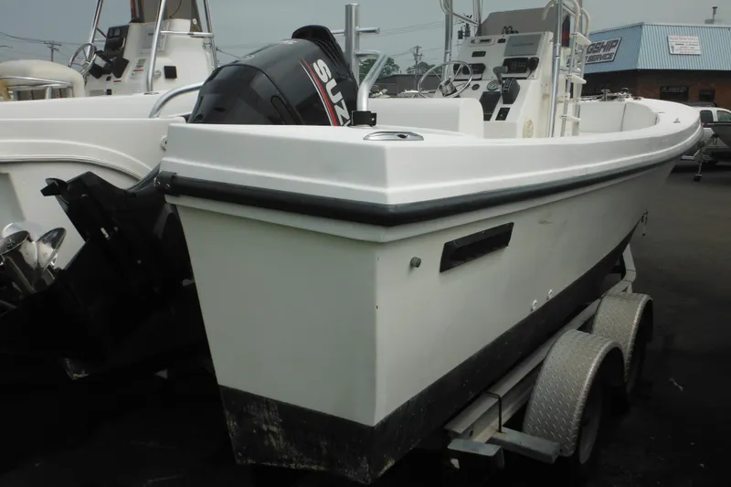 Slide: The Image of 2006 DC 23 DC Brown Custom CC boat on trailer with Suzuki outboard motor. - 4