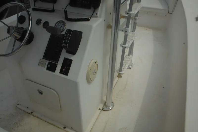 Slide: The Image of 2006 DC 23 Brown Custom CC boat console with steering wheel and controls. - 40