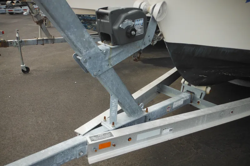 Slide: The Image of Trailer hitch of a 2006 DC 23 DC Brown Custom CC boat on asphalt. - 43