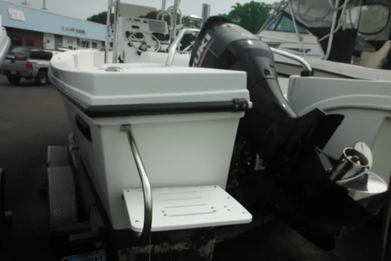 Slide: The Image of 2006 DC 23 DC Brown Custom CC boat with Suzuki outboard motor in a marina setting. - 6