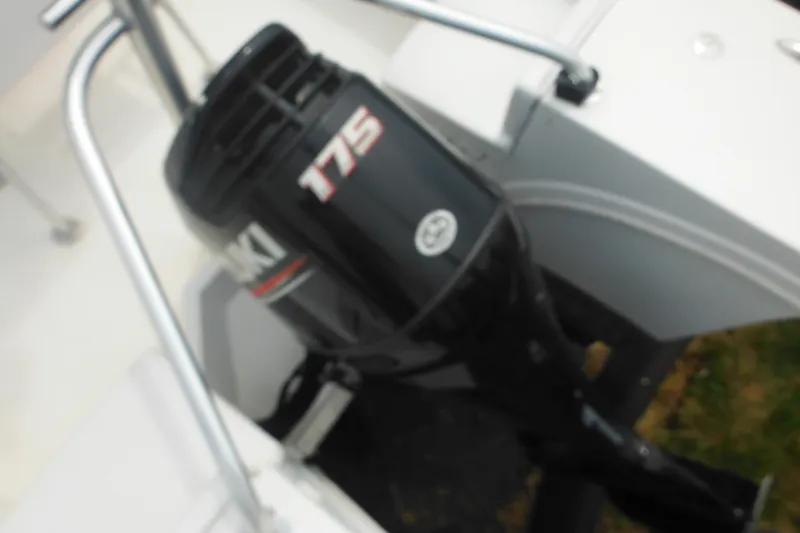 Slide: The Image of Outboard motor on 2006 DC 23 DC Brown Custom CC boat, featuring Suzuki 175 engine. - 9