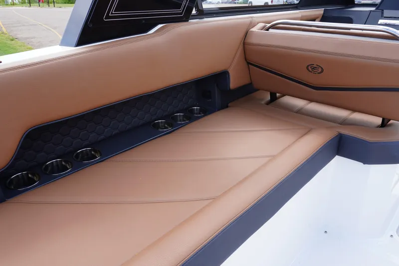 Slide: The Image of 2025 Cobalt R8 Surf boat interior with tan leather seating and cup holders. - 10