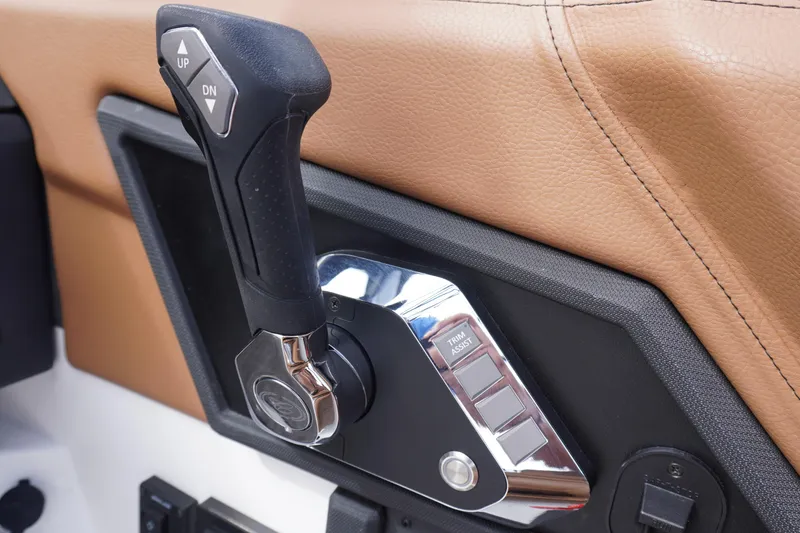 Slide: The Image of Throttle control lever in 2025 Cobalt R8 Surf boat, featuring ergonomic design and trim assist. - 12