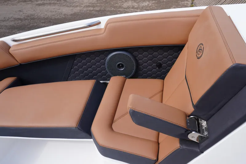 Slide: The Image of Luxurious tan and black seating in 2025 Cobalt R8 Surf boat interior. - 19