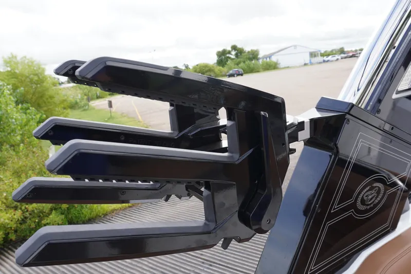 Slide: The Image of 2025 Cobalt R8 Surf boat with sleek black wakeboard rack design. - 23