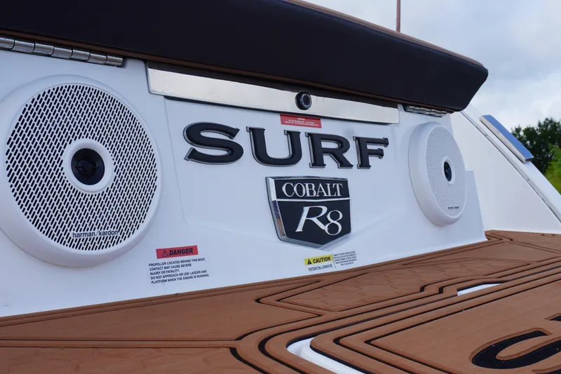 Slide: The Image of 2025 Cobalt R8 Surf boat with Harman Kardon speakers and stylish design. - 7