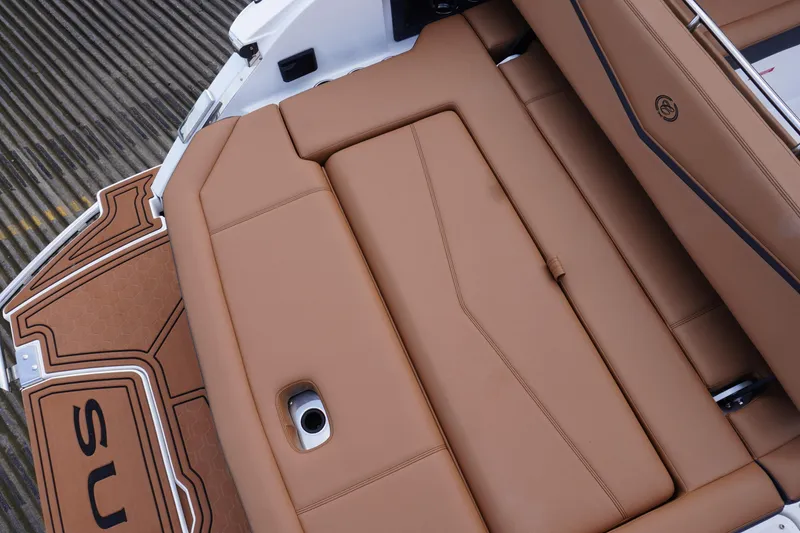 Slide: The Image of 2025 Cobalt R8 Surf boat with luxurious tan leather seating and sleek design. - 8