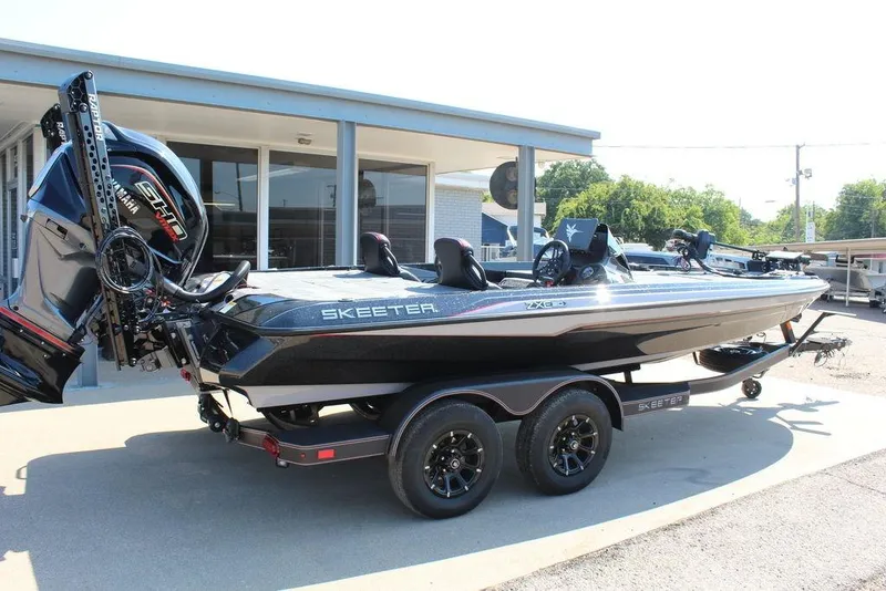 Slide: The Image of 2026 Skeeter ZXE20 boat with Yamaha engine on a trailer, parked outdoors. - 7