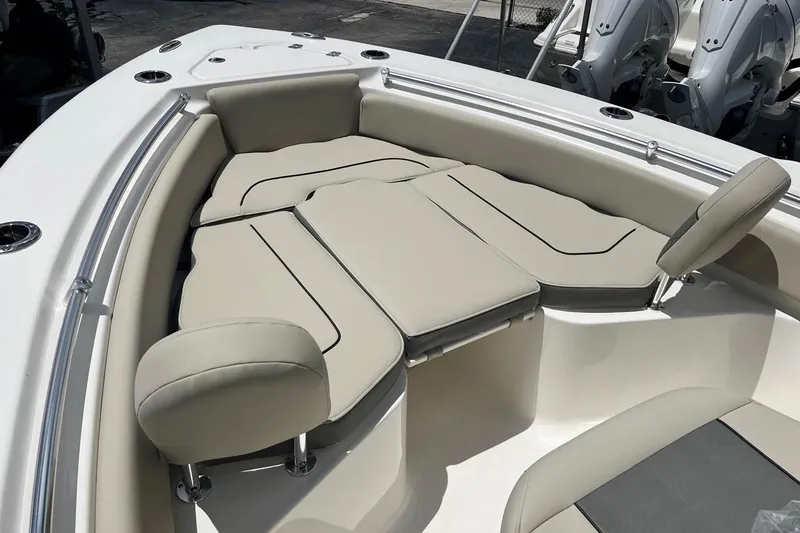 Slide: The Image of 2026 Key West 219 FS boat interior with beige cushioned seating and stainless steel fixtures. - 10