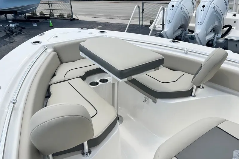 Slide: The Image of 2026 Key West 219 FS boat interior with cushioned seating and table setup. - 11