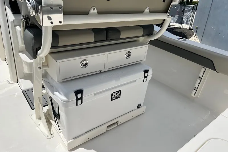 Slide: The Image of 2026 Key West 219 FS boat interior with storage compartments and cooler. - 19