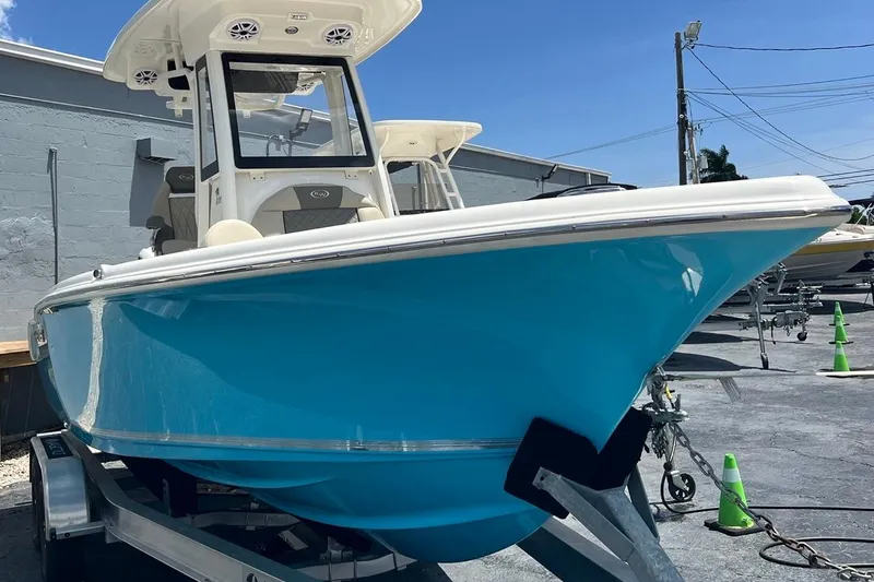 Slide: The Image of 2026 Key West 219 FS boat in vibrant blue on a trailer, outdoor setting. - 2