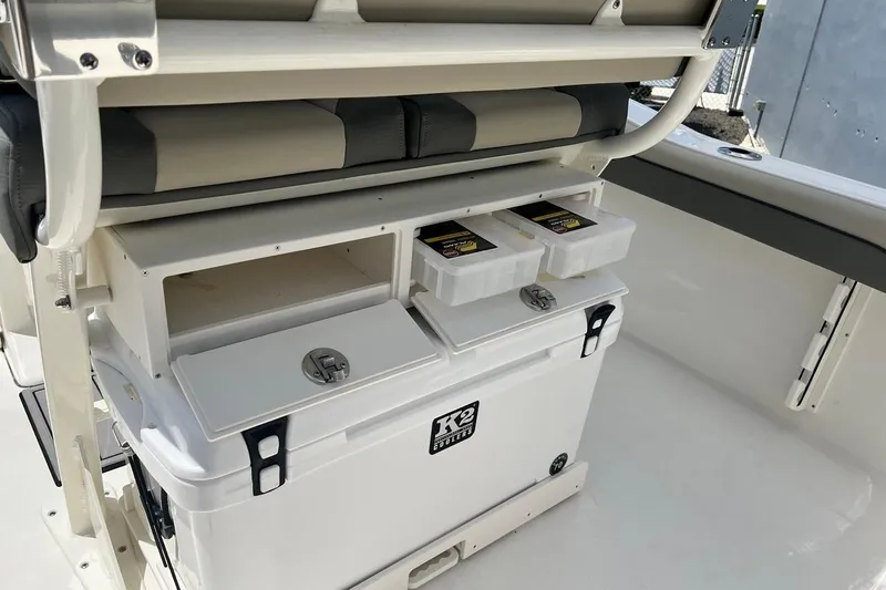 Slide: The Image of Interior of 2026 Key West 219 FS boat featuring storage compartments and cooler. - 21