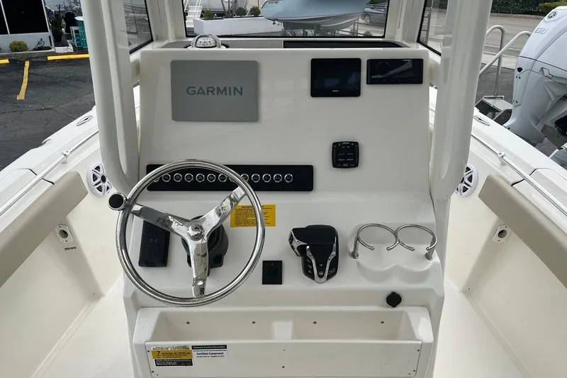Slide: The Image of 2026 Key West 219 FS boat dashboard with Garmin navigation system and steering wheel. - 22