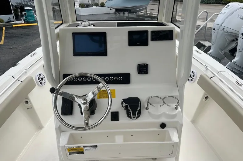 Slide: The Image of 2026 Key West 219 FS boat dashboard with steering wheel and control panel. - 23