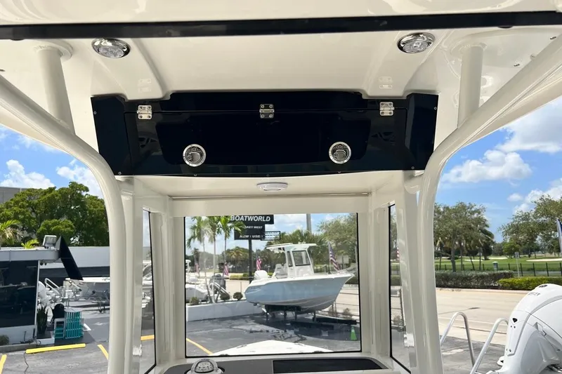 Slide: The Image of 2026 Key West 219 FS boat interior with overhead console and outdoor view. - 27